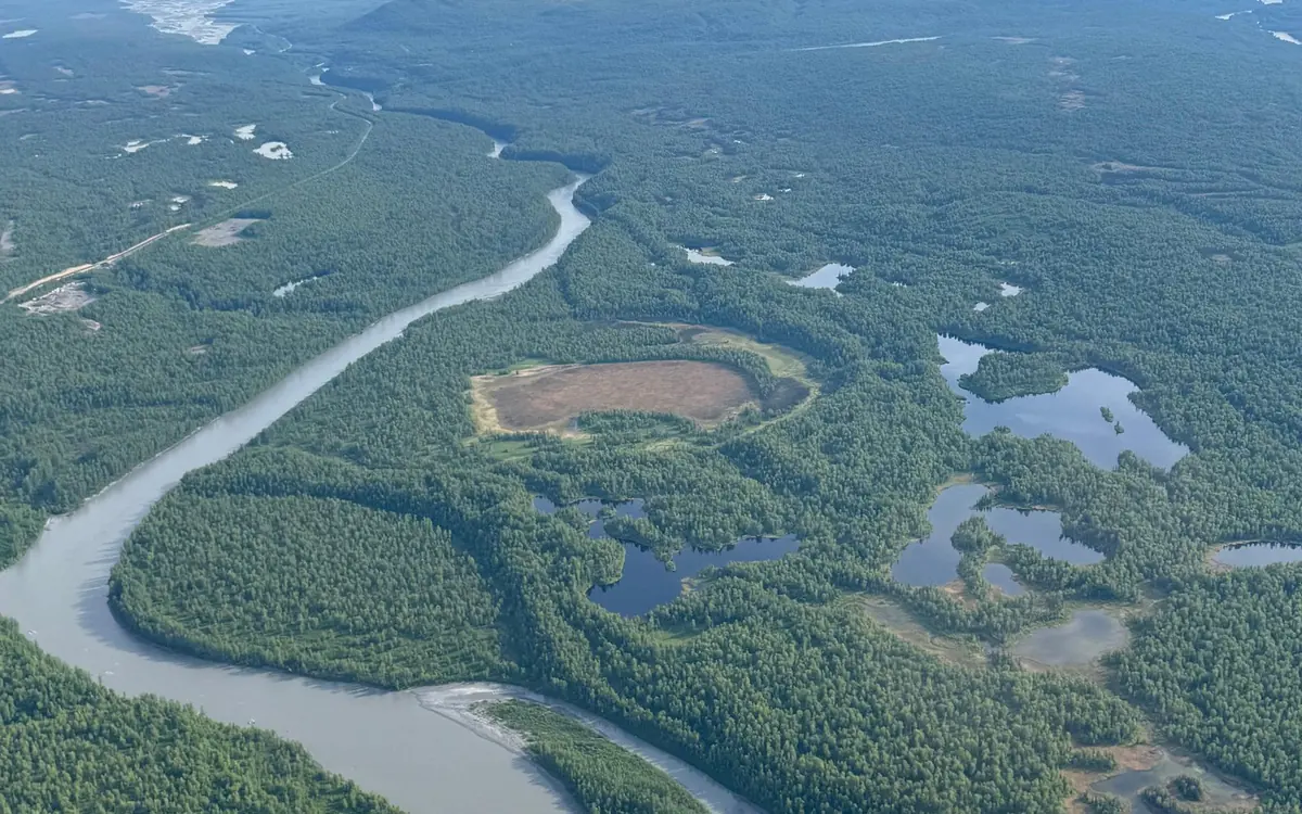 Braided river channels and open tundra seen from the window of a small aircraft south of the Alaska Range